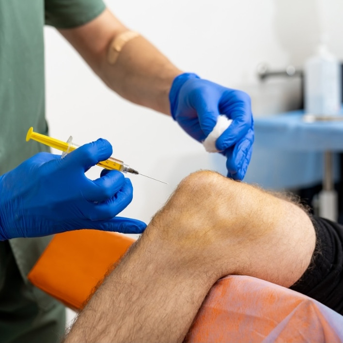 person having a steroid injection in the knee