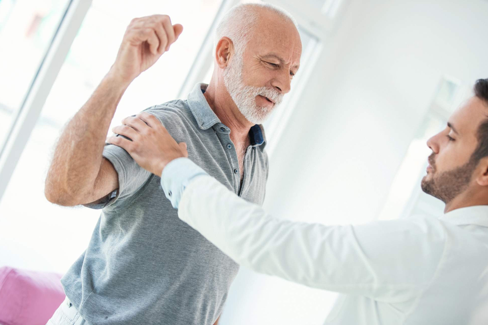 Frozen shoulder and injection therapy 3 specialist physiotherapist checking a persons arm